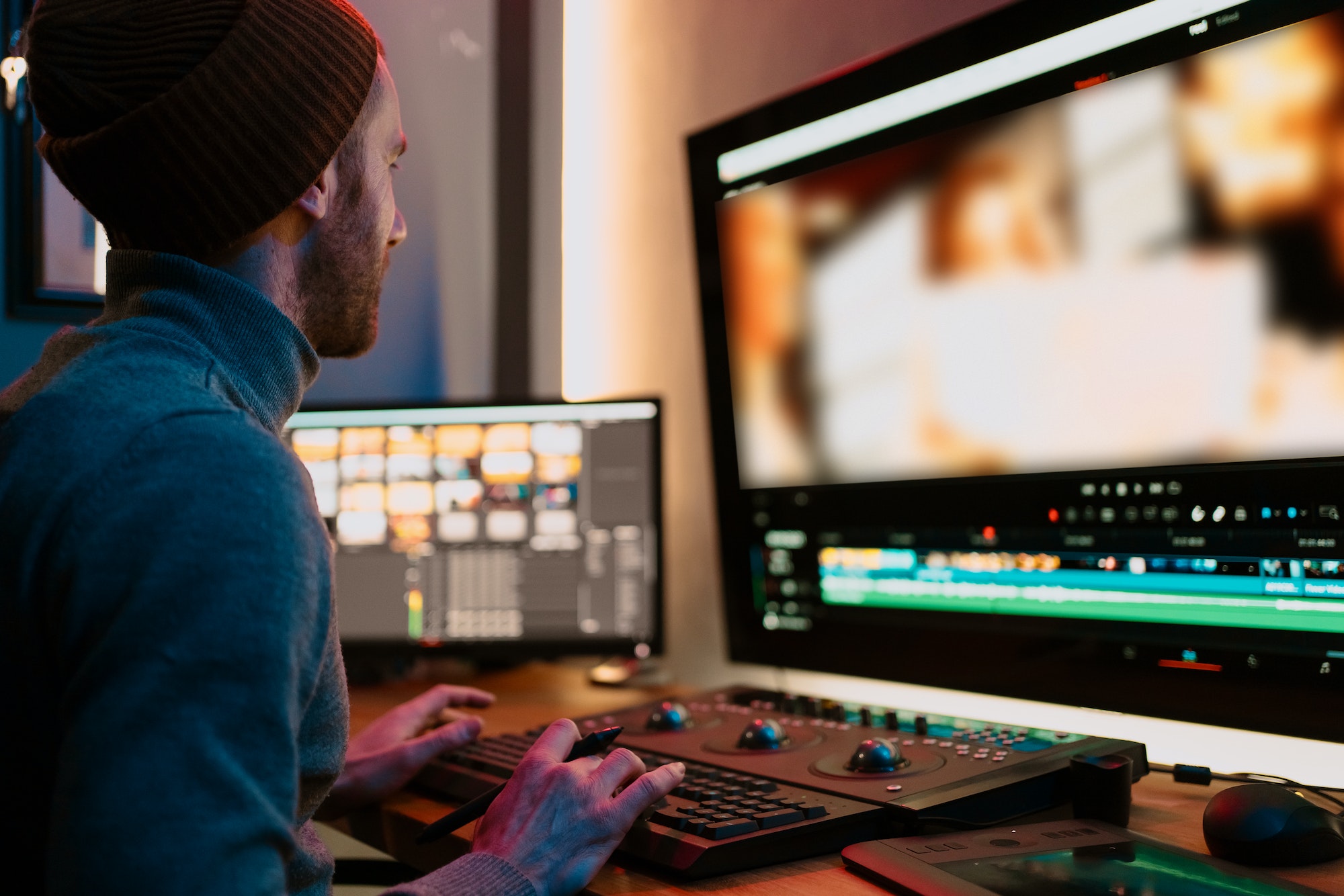 Male Video Editor Working on His Personal Computer with Big Display